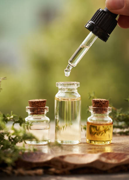 istock Dropping aromatherapy essential oil from a pipette into a bottle outdoors in nature 2171781450