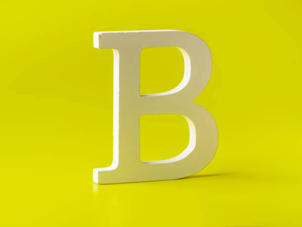 Wooden uppercase letter B on a colored background