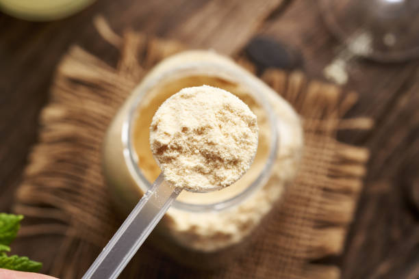 istock Whey protein powder in a measuring scoop above a jar 2171783646