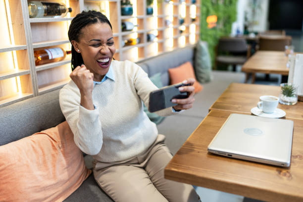 istock Woman using a phone in a cafe 2171788434