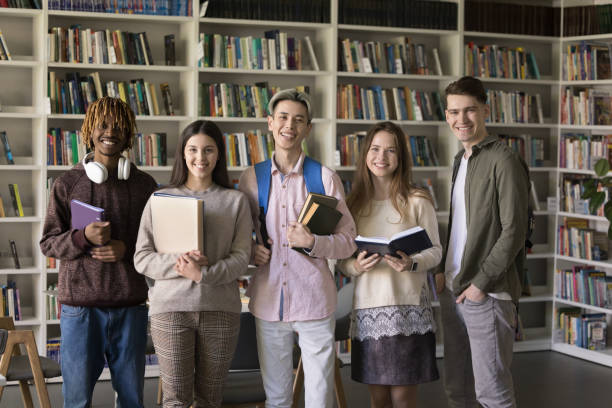 istock Happy diverse college students posing for group portrait in library 2171788934
