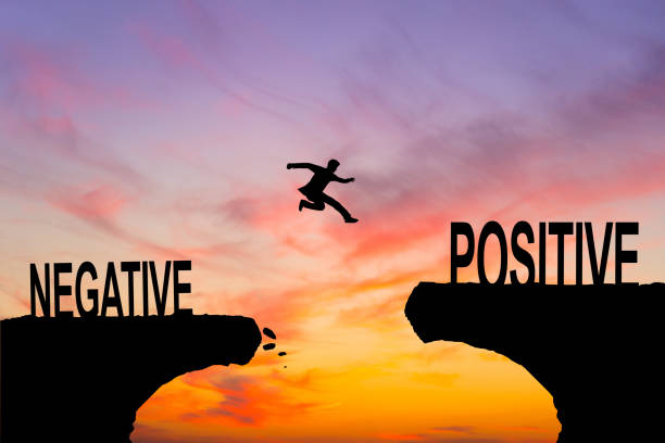 istock A man jump through the gap between Negative to Positive on sunset. 2171790080