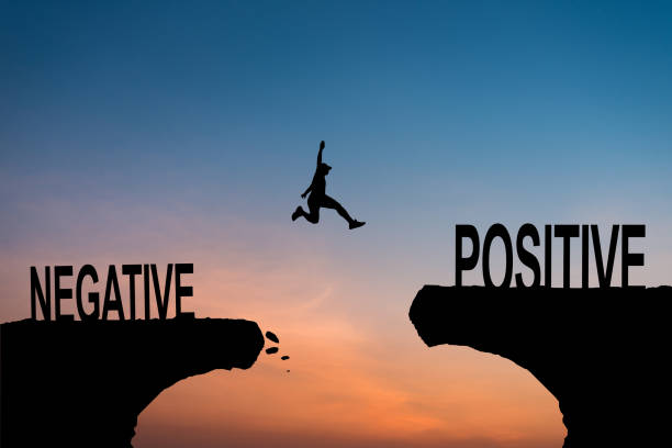 istock A man jump through the gap between Negative to Positive on sunset. 2171790084