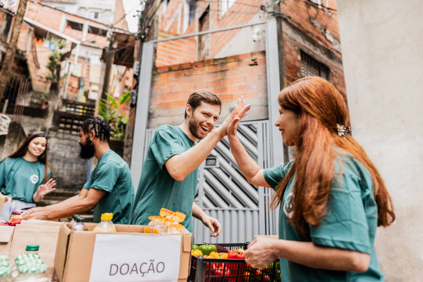 istock Volunteers doing high five outdoors 2171791687