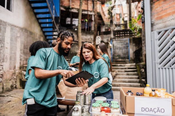 istock Volunteers using digital tablet during donation outdoors 2171791861