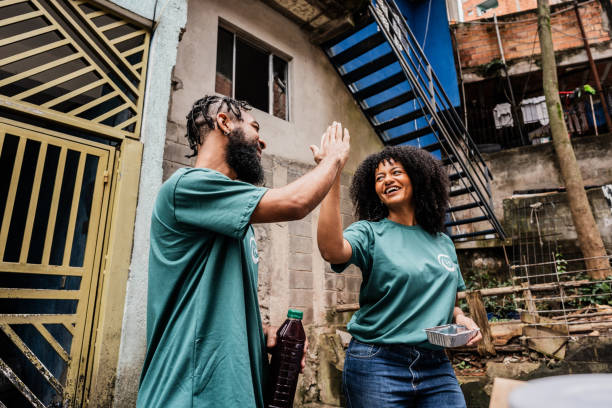 Volunteers doing high five outdoors