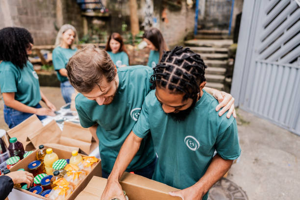 istock Volunteers men arranging items outdoors 2171791993