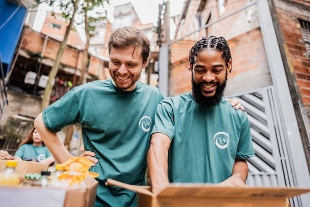 istock Volunteers men arranging items outdoors 2171792000