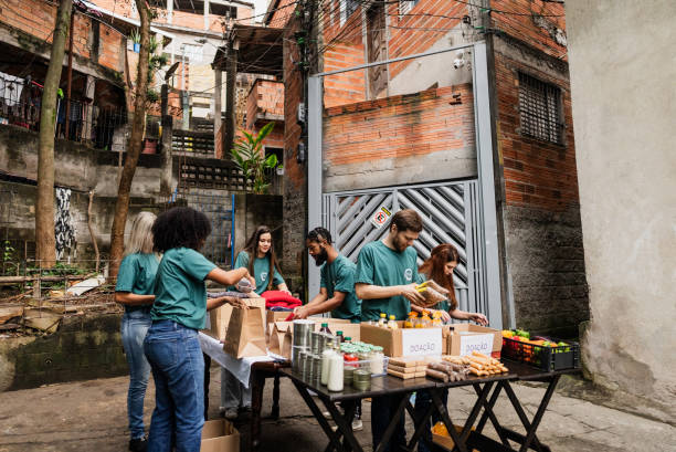 istock Volunteers arranging items for donation outdoors 2171792096