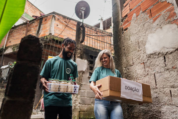Volunteers carrying donation box outdoors