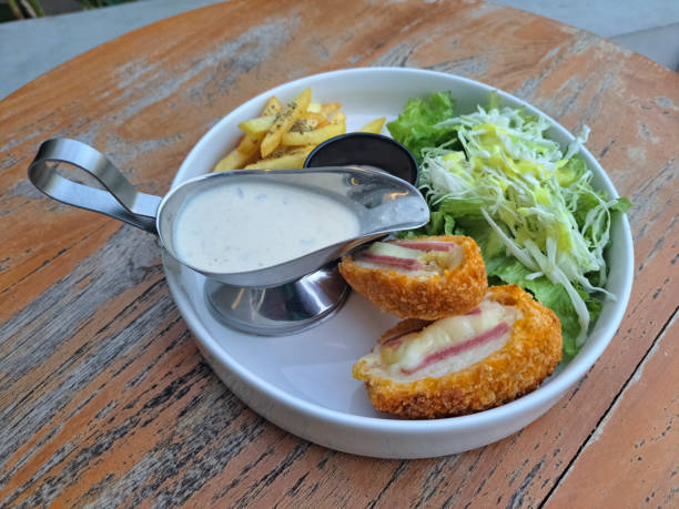 Yummy Chicken Cordon Bleu Is Chicken Roll With Bacon, Mozarella, Salad And French Fries. Food Menu.