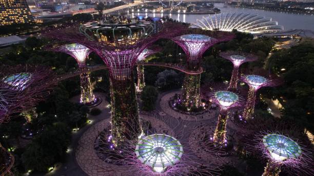 Marina Bay, Singapore - July 13, 2022: The Landmark Buildings and Tourist Attractions of Singapore. Aerial View of the MBS Hotel, Casino, Science Center, Ferris Wheel, and lake in front of Bayfront, Singapore Flyer and Gardens by the Bay at dawn and dusk. Stunning views