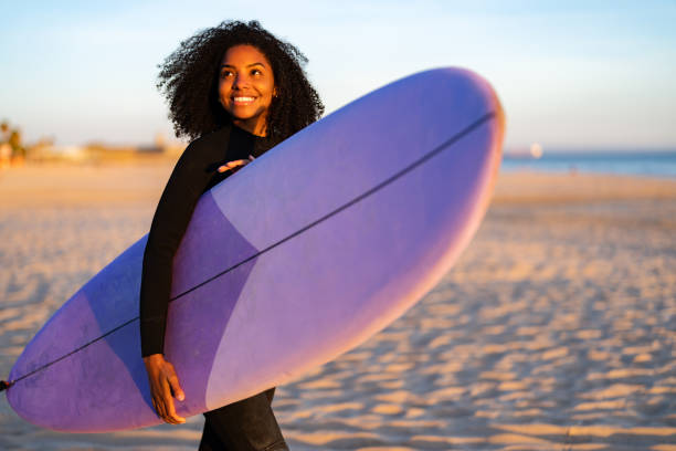 istock Joyful Black Female Surfer with Board on Beach 2171818583