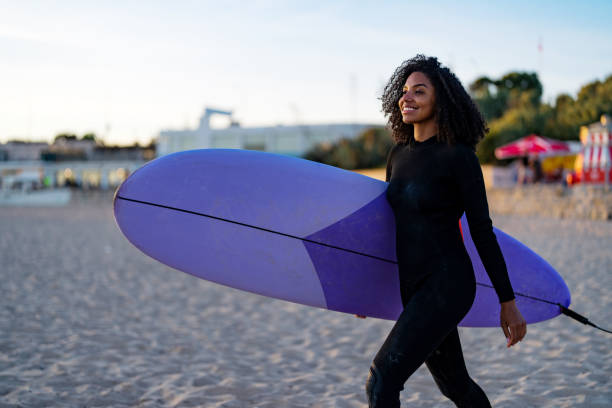 istock Joyful Black Female Surfer with Board on Beach 2171818586