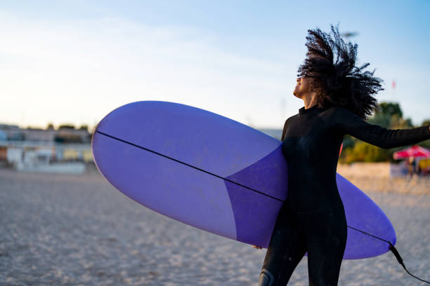 istock Joyful Black Female Surfer with Surfboard on Beach 2171818591