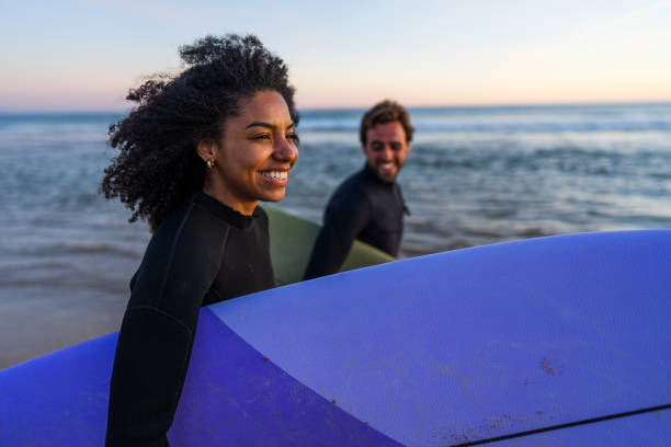 istock Diverse Couple with Surfboards at Seaside Sunset 2171818621