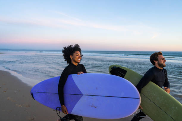 istock Diverse Couple with Surfboards on Beach at Sunset 2171818630
