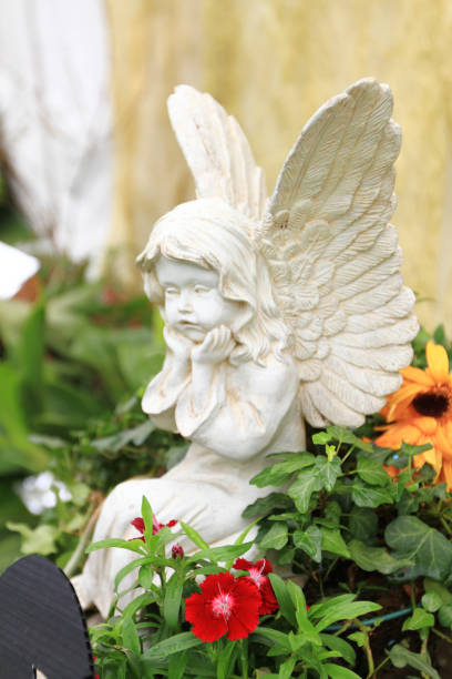 Statue of angel with hand raised in sunlight, from cemetery build in 1864, Czech Republic, background with copy space, full frame horizontal composition