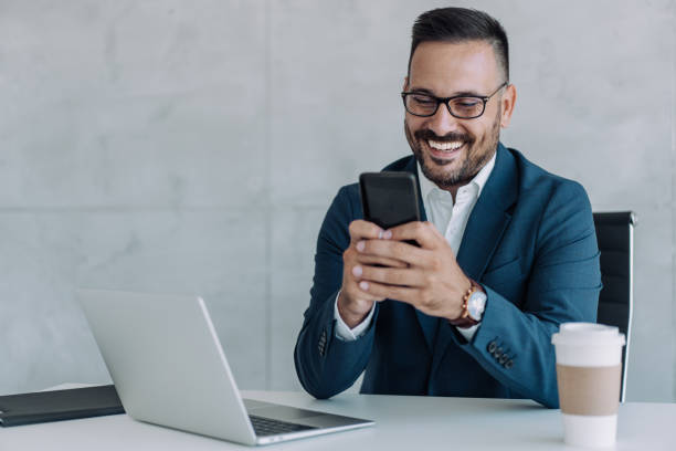 istock Businessman texting on cellphone in the office. 2171828550