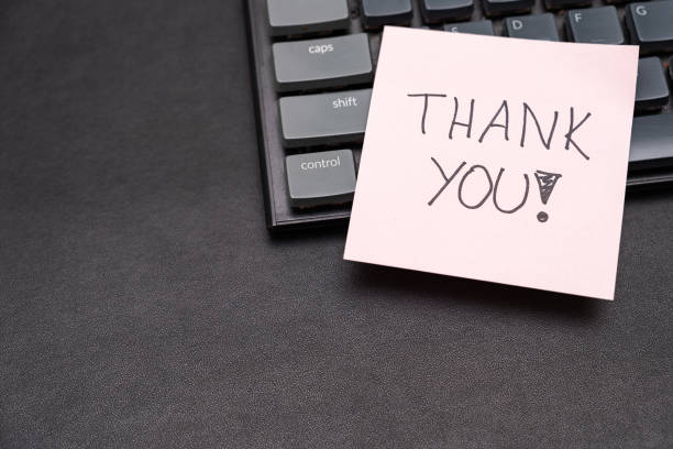 istock Hand writing THANK YOU on pink sticky note on keyboard. Copy space. 2171832958