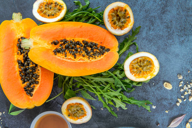 istock Papaya, passion fruit and rucola on a blue stone kitchen table background 2171850575