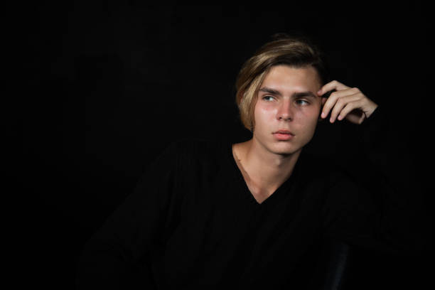 istock A young attractive guy is sad while sitting on a chair. 2171855294