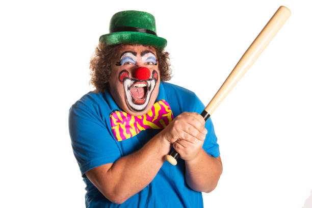 Entertainer holding a red wig and clown nose for a performance