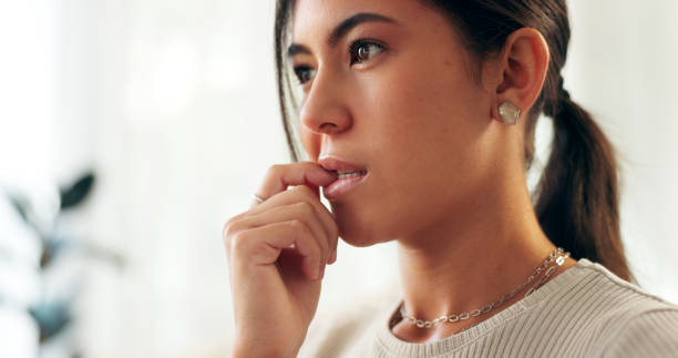 istock Woman, house and anxiety with biting nails for thinking or stress or crisis with problem solving. Female person, home and worried or nervous as student for exam or test results with panic or fear 2171863912