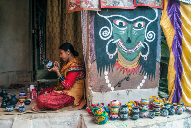 West Midnapur, West Bengal, India 11.16.2024. A woman artist working at her home and displayed her art works which she and her family already made for sale in a local fair.