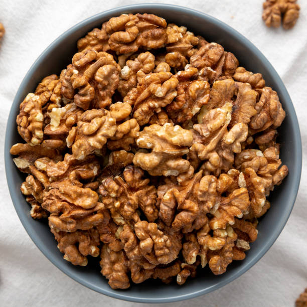 istock Raw Organic Walnuts in a Bowl, top view. Flat lay, overhead, from above. Close-up. 2171878944