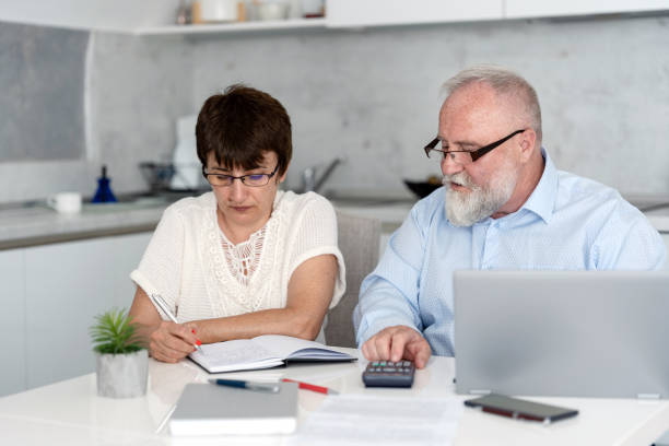 istock Mature couple planning their home budget using laptop 2171884262