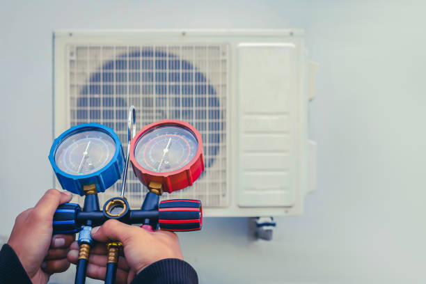 istock Air conditioning, HVAC service technician using gauges to check refrigerant and add refrigerant. 2171886137