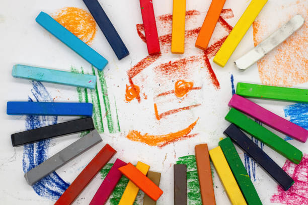 multicoloured mlky collected in the form of a sun with a face inside on painted paper for design and decoration of pre-school school website, books, brochures, background design