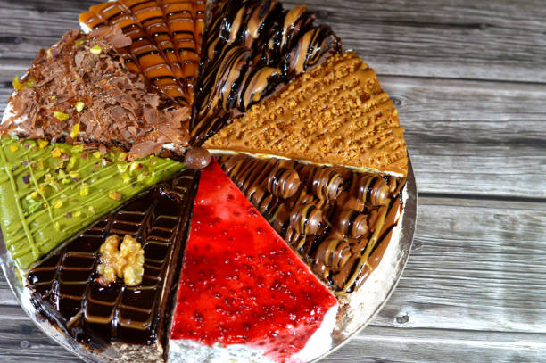 istock Spongy cake pieces with assorted toppings and fillings with whipped cream, chocolate paste, chunks and balls of chocolates 2171887247