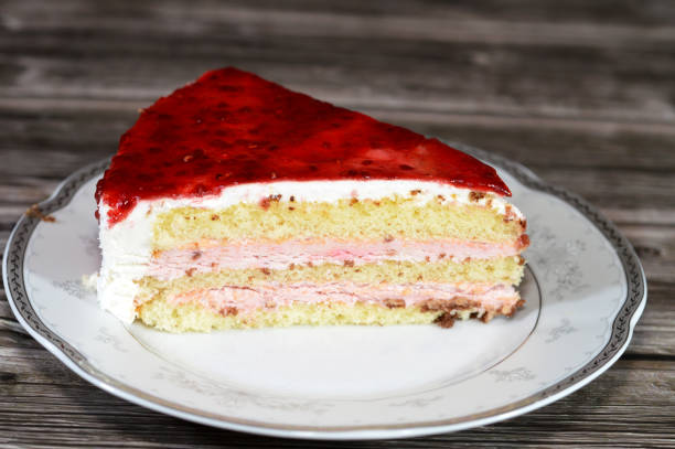 istock Berry triangular spongy cake piece filled and topped with layers of berries paste cream, with layers of cake 2171887967