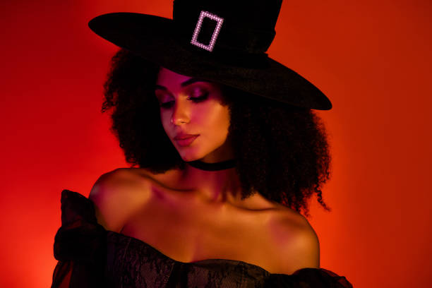 istock Photo of tender gentle lady witch using dark evil magic for wicked medieval gothic men over red background 2171888787
