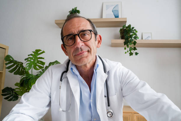 istock Senior doctor smiling wearing lab coat and stethoscope making video conference call 2171893705