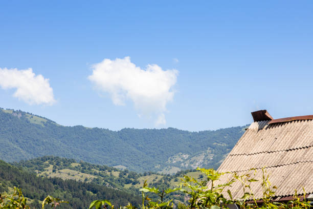 blue sky with white cloud over mountains surrounding Dilijan city on sunny summer morning