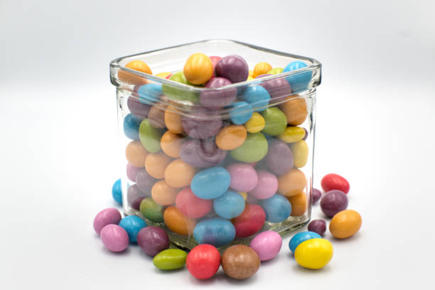 Colorful chocolate candies in decorative glass, snack.