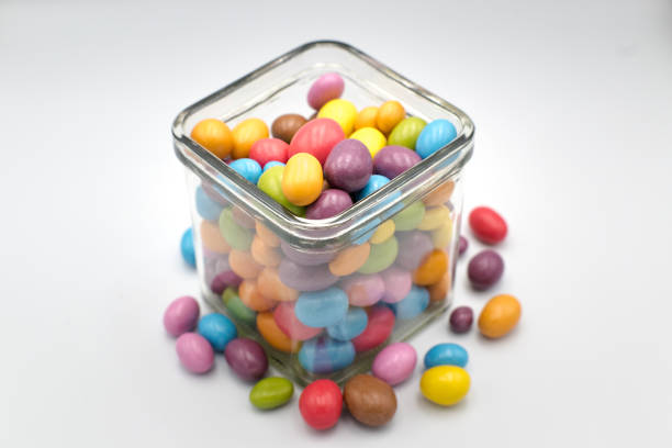 Colorful chocolate candies in decorative glass, snack.