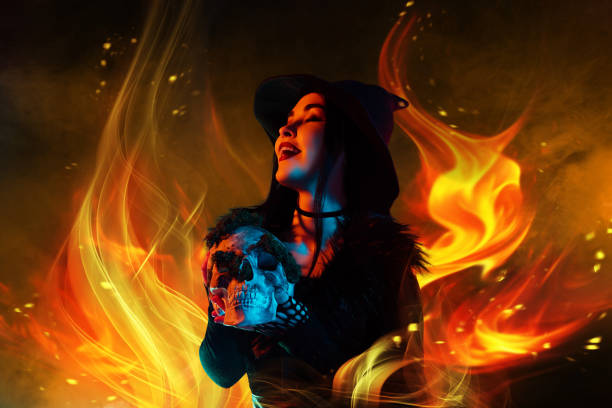 istock Surreal artwork design collage of dark witch lady evil laughing hold skull over dark fire flame background 2171897672