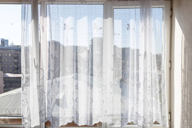 istock tulle curtains on home window and view of roof 2171898099