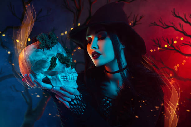 istock Abstract creative artwork collage of dark witch lady hold skull in fire flame picture dark background 2171898449