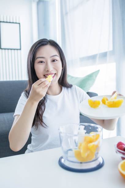 istock Asian woman eating an orange 2171905467