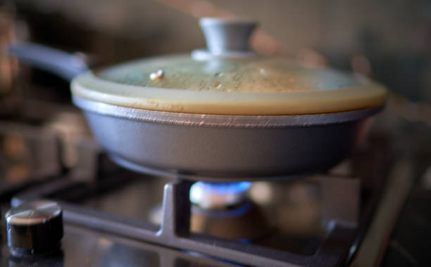 istock frying pan stands on gas stove in restaurant 2171907517