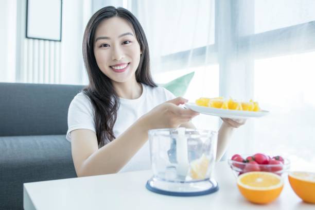 istock Asian woman making orange juice in the kitchen 2171907739