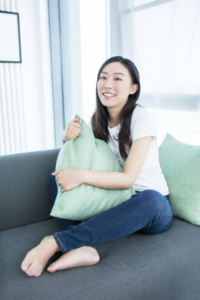 istock Young woman with soft pillow at home 2171915263