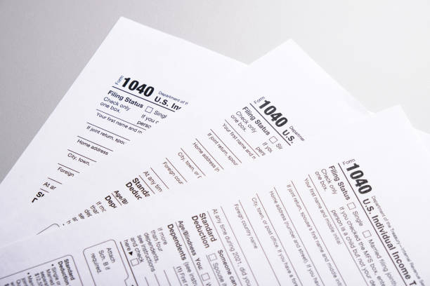 istock Tax form 1040 forms lying on table close-up, tax concept 2171915307