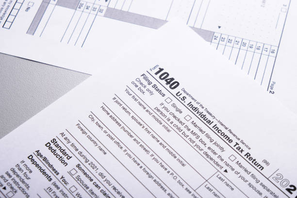 istock Tax form 1040 forms lying on table close-up, tax concept 2171915313