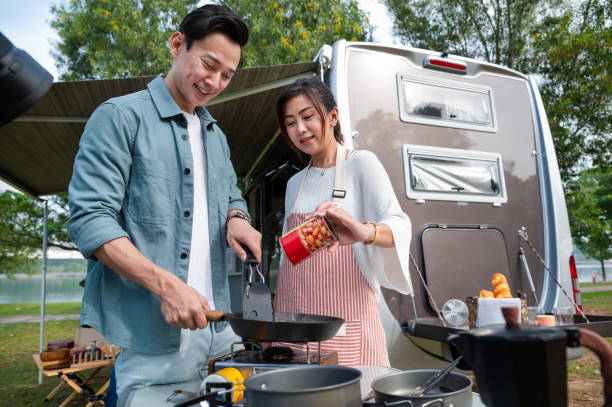 istock Asian couple preparing breakfast meal beside the camper van 2171915331